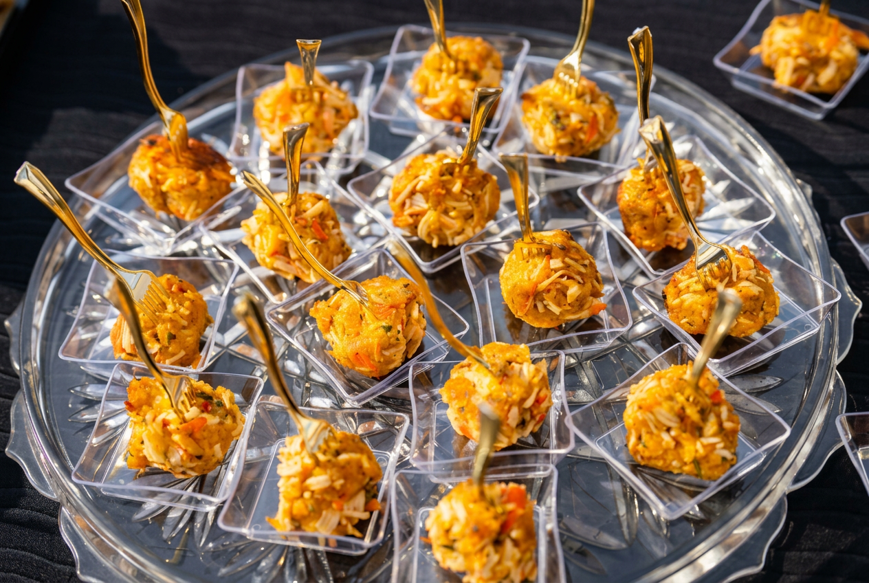 Bite-size catered appetizers served with gold tasting forks